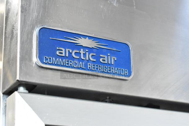 Arctic Air stainless steel commercial cooler, 2 doors, poly coated racks, 115V. Brand label reads "Arctic Air Commercial Refrigerator."