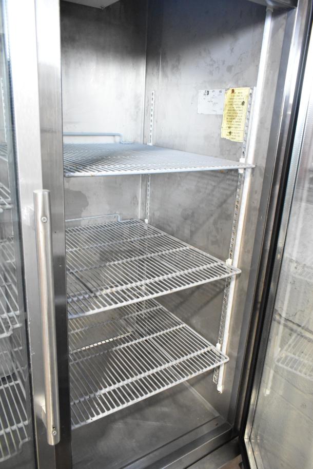 Arctic Air stainless steel commercial 2-door reach-in cooler with poly-coated racks. Condition: used. 115 volts, 1 phase.