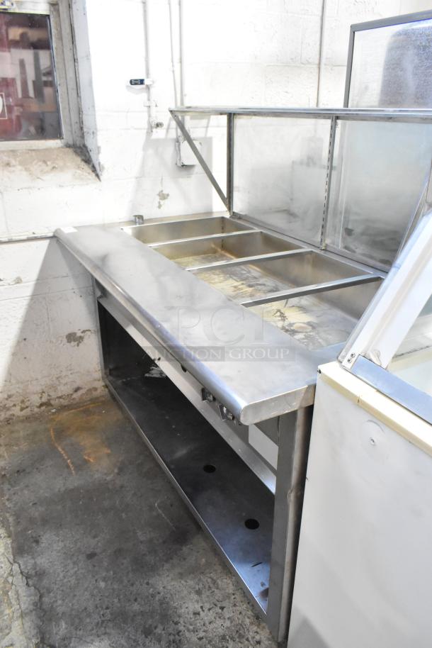 Stainless steel steam table with sneeze guard, under shelf, three compartments, used condition. Ideal for commercial kitchens.