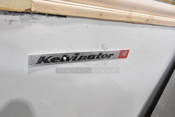 Kelvinator metal commercial ice cream dipping cabinet, white, with branded logo. Features durable construction, suitable for commercial use.
