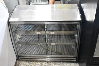 Vendo HFDC00003 metal heated display case, 115V, 1 phase, glass front, stainless steel interior, shelves with "Caution Hot" labels.