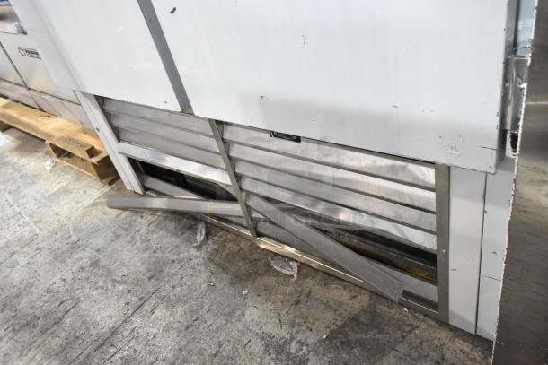 2025 Leader ESFR54 stainless steel commercial 2-door cooler with visible damage. Poly-coated racks, 115 volts, 1 phase.