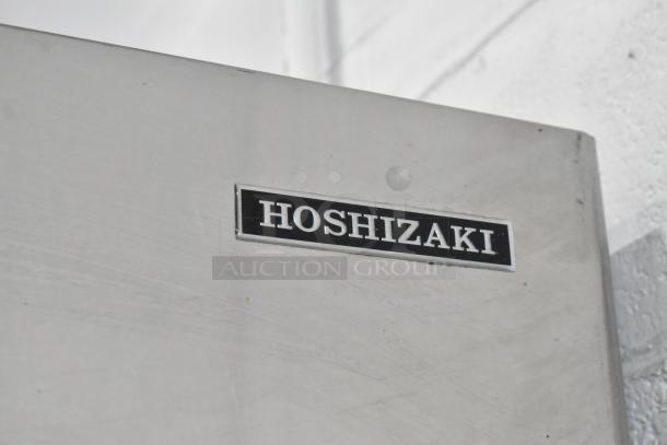 Hoshizaki F-1001MWH stainless steel commercial ice head on ice bin, 208-230V, 1 phase, with brand nameplate visible.
