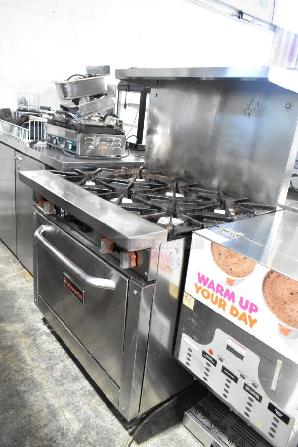 Sierra stainless steel commercial gas 6-burner range with oven, over shelf, and backsplash. Used condition, marked $1500.