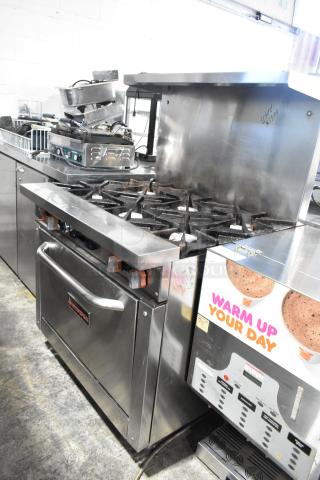 Sierra stainless steel commercial gas 6-burner range with oven, over shelf, and backsplash. Used condition, marked $1500.