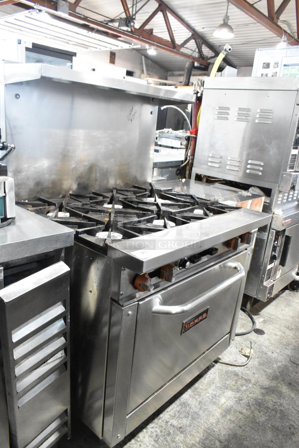 Sierra stainless steel commercial 6-burner gas range with oven, over-shelf, and backsplash. Good condition.
