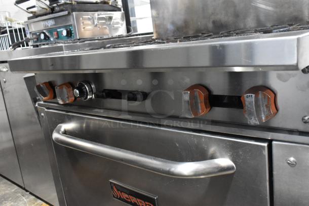 Sierra commercial gas range, stainless steel, 6 burners, oven, overshelf, backsplash, brand logo visible, used condition.