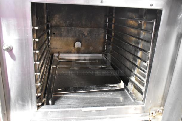 Market Forge stainless steel steam cabinet interior showing shelves, well-maintained. Ideal for commercial use.