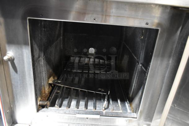 Market Forge stainless steel single deck steam cabinet, used condition, interior view showing racks and slight wear.