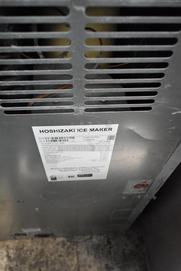 Hoshizaki DCM-500BAH commercial ice machine with water dispenser, stainless steel, label shows model and voltage details.