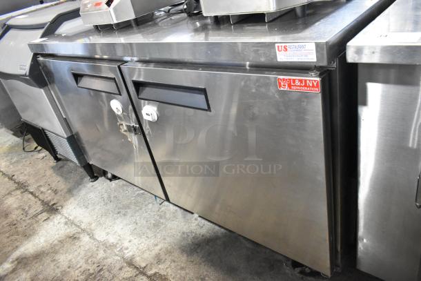 L&J NY JUC-60 stainless steel 2-door undercounter cooler on casters, 115V, used condition, visible brand label.