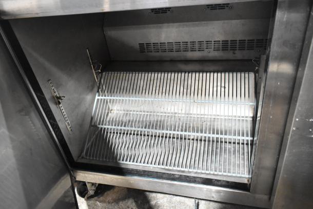 L&J NY JUC-60 stainless steel 2-door undercounter cooler, commercial casters, 115V, 1-phase. Interior wire shelf shown.