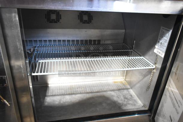 L&J NY JUC-60 stainless steel 2-door undercounter cooler with shelves, commercial casters, visible label, 115V, 1 phase.