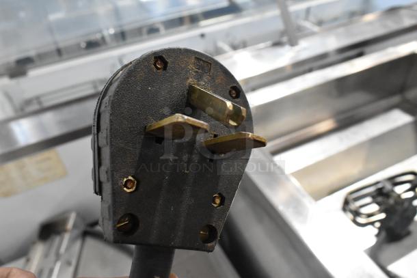 Plug of Turbochef NGC Stainless Steel Rapid Cook Oven, 208/240V, 1 Phase, showing prongs and condition.