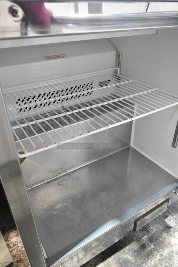 Maxx Cold MXCR29S stainless steel prep table, interior view, commercial casters, clean shelves, visible wiring, 115V, 1 Phase.