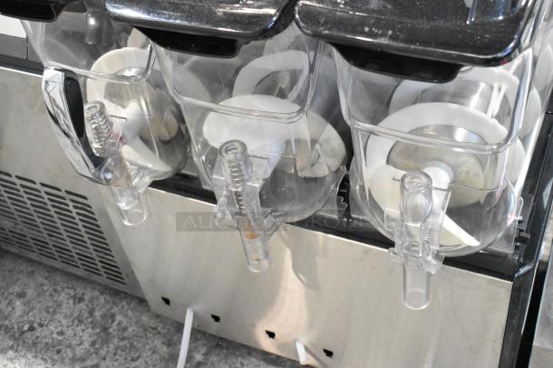 Metal commercial countertop 3 hopper slushie machine, 115 volts, 1 phase. Clear hoppers, stainless steel exterior, good condition.