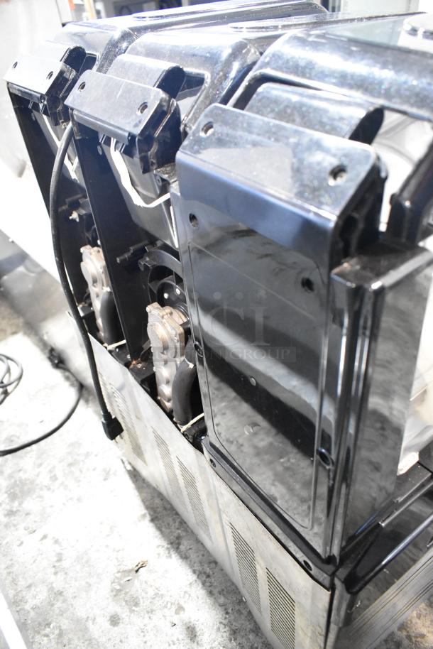 Commercial metal countertop slushie machine with 3 hoppers, 115 volts, 1 phase. Black exterior, showing detail of compartments.