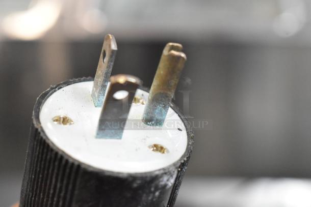 Alt text: Close-up of plug from Edlund CH-5000 Hydraulic Can Crusher, showing wear. 115 Volts, 1 Phase.