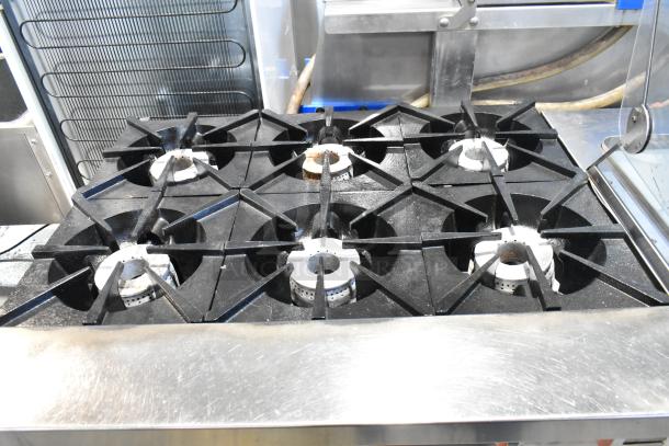 Sierra stainless steel commercial gas 6-burner range with oven, on casters, in good condition.