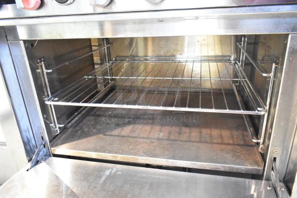 Sierra stainless steel 6 burner range with oven, commercial gas-powered, on casters, clean interior, robust construction.