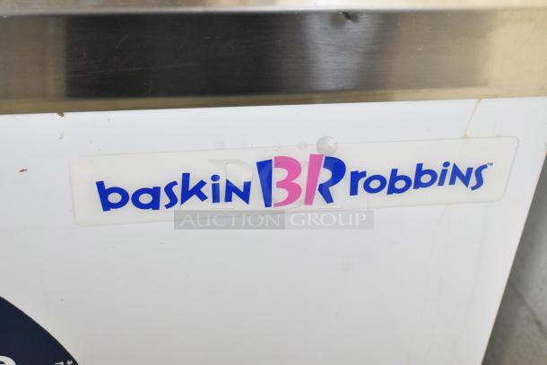 Metal commercial Baskin Robbins floor-style ice cream dipping cabinet with tub collars, 115 volts, 1 phase.