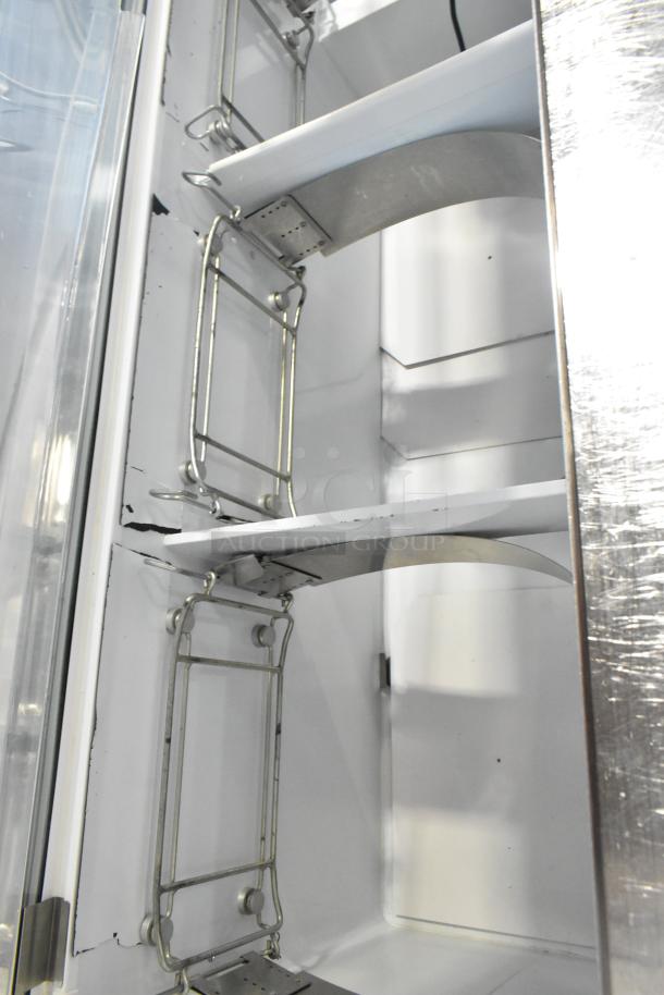 Metal commercial ice cream dipping cabinet with tub collars, 115 volts, 1 phase. Visible wear on the interior surfaces.