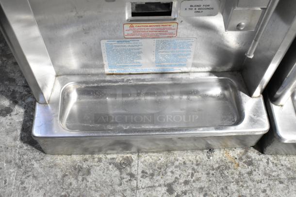 Taylor 340D-27 stainless steel commercial countertop frozen beverage machine with drink mixer. Visible instruction label. Condition shows signs of use.