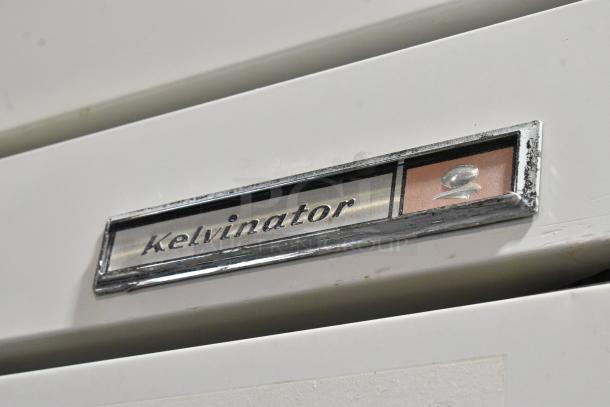 Kelvinator T3OHSP-4 metal commercial reach-in hardening cabinet with logo and label shown. Single door, poly-coated racks.