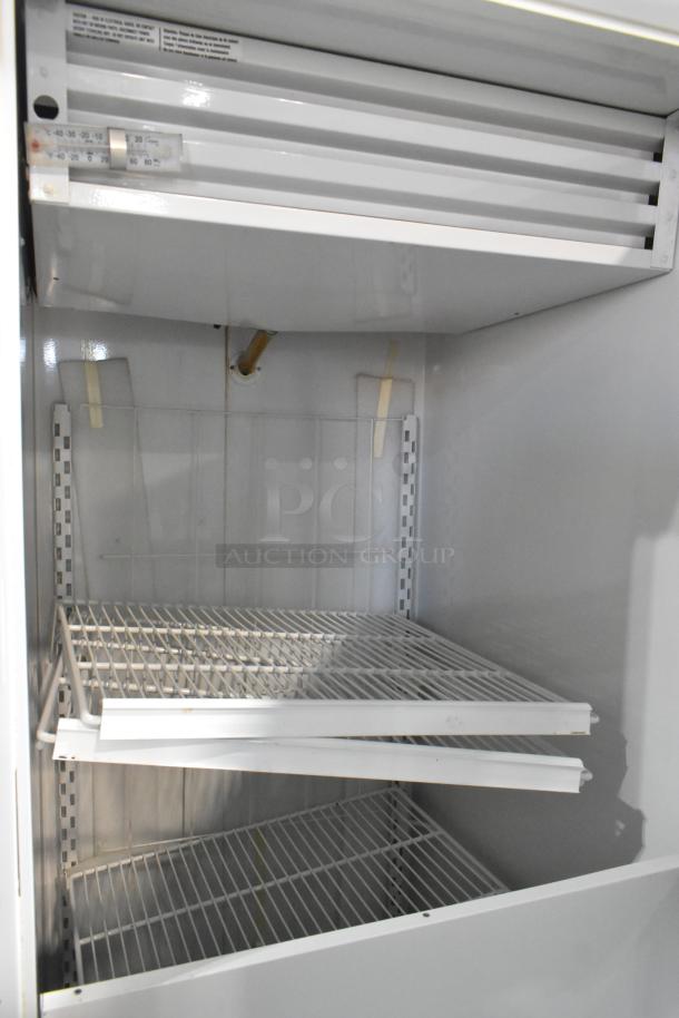 Kelvinator T3OHSP-4 commercial hardening cabinet, metal, single door, with poly-coated racks. 115V, 1 phase, good condition.