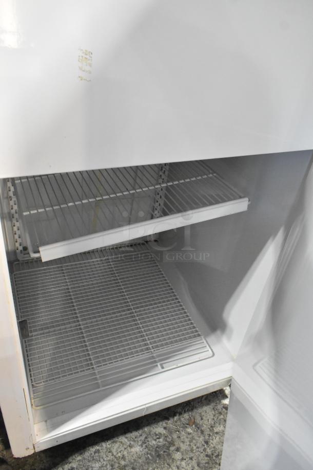 Kelvinator T3OHSP-4 commercial reach-in hardening cabinet with poly-coated racks, single door, 115V, seen open with racks inside.