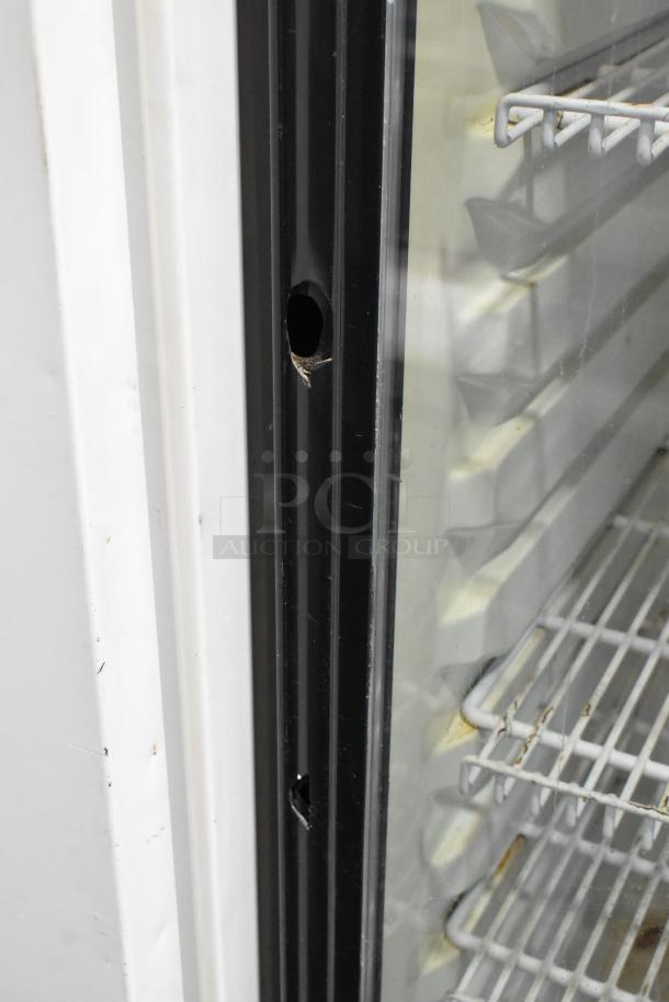 Turbo Air TGM-22R single door cooler detail, shows interior shelving and frame, 115 volts, 1 phase. Visible wear on door.