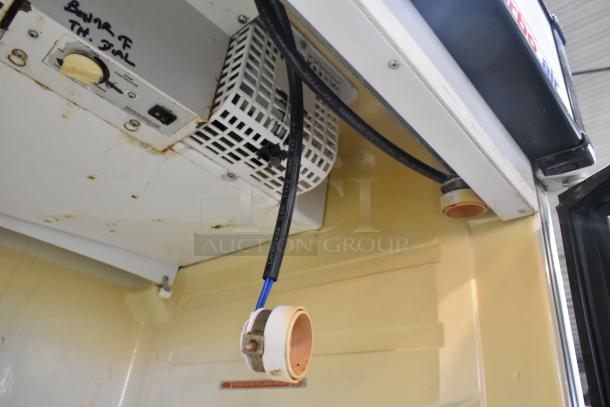 Turbo Air TGM-22R cooler interior, showing thermostat dial and electrical connections. Rust visible, indicating used condition.