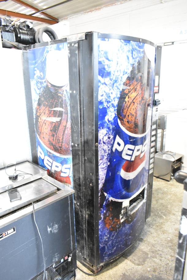 Metal commercial floor-style vending machine with Pepsi branding and bill acceptor; missing key, 115 volts, 1 phase.