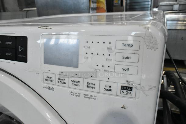 Whirlpool WFW5620HW2 front load washer, 120V, 1 phase. Features include Temp, Spin, and Soil settings. Visible wear on surface.