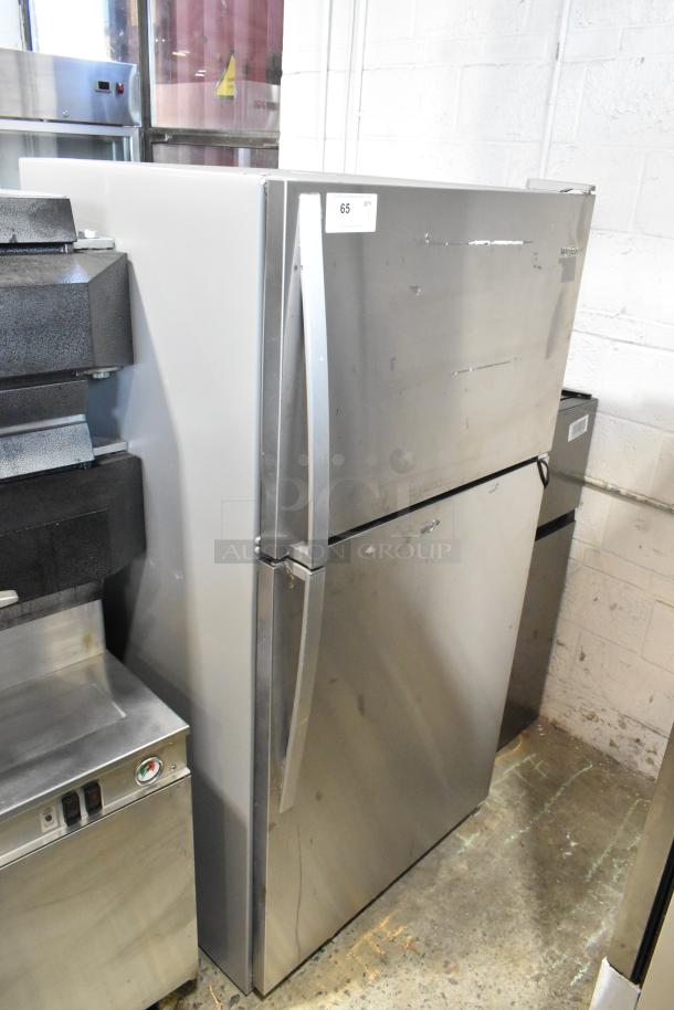 2020 Whirlpool WRT311FZDM01 stainless steel refrigerator with top freezer, 115V, 1 phase. Some surface wear visible.