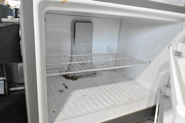 2020 Whirlpool WRT311FZDM01 stainless steel cooler with freezer; interior view shows shelf; 115 volts, 1 phase.