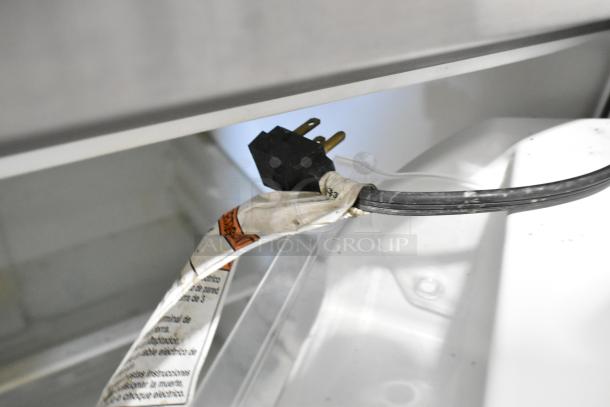 2020 Whirlpool WRT311FZDM01 stainless steel cooler with freezer, 115 volts, 1 phase; shows power cord and label.