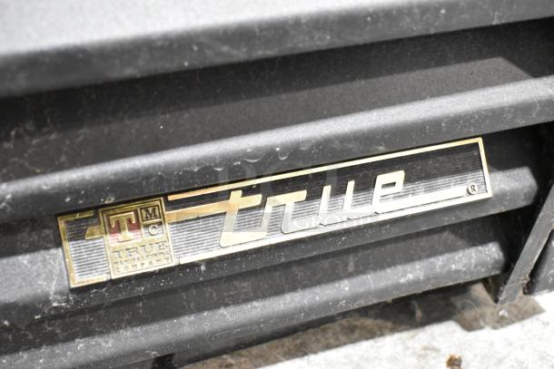 True GDM-41SL-60-LD 2 Door Cooler Merchandiser label, showing brand and model on metal surface.