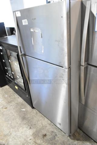 2024 Whirlpool WRT311FZDM15 stainless steel fridge with freezer, 115V, 1 Phase. Visible wear on the door surface.