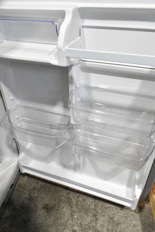2024 Whirlpool WRT311FZDM15 stainless steel refrigerator with freezer, 115 volts, 1 phase, interior shelves shown.