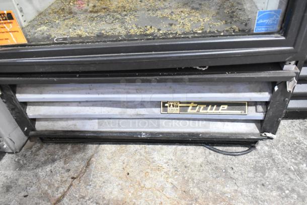 True GDM-12 commercial cooler with single glass door, metal exterior, poly-coated racks, and visible True logo. 115 volts, 1 phase.
