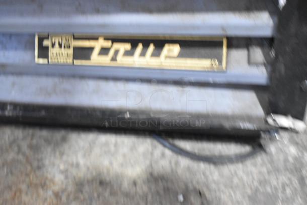 True GDM-12 logo on a metal commercial reach-in cooler, single door, with poly-coated racks, 115V, 1 phase.