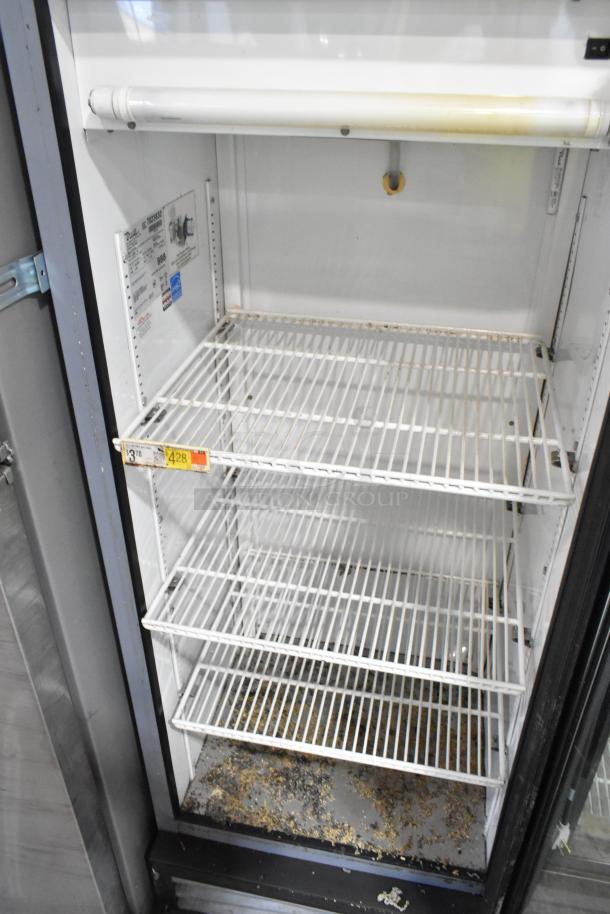 True GDM-12 metal single door cooler with poly coated racks, visible surface stains. 115 volts, 1 phase. Interior label shown.