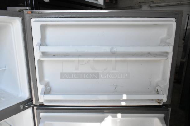 2019 Whirlpool WRT311FZDM01 stainless steel cooler with freezer. Two door shelves visible. 115 Volts, 1 Phase.