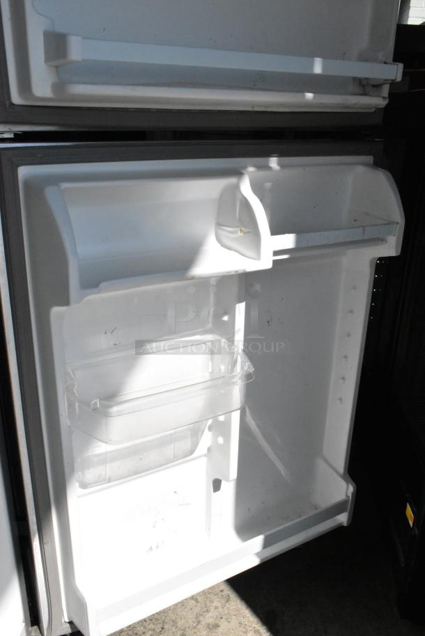 2019 Whirlpool WRT311FZDM01 stainless steel refrigerator with freezer. Interior shelves visible, clean condition. 115V, 1 phase.