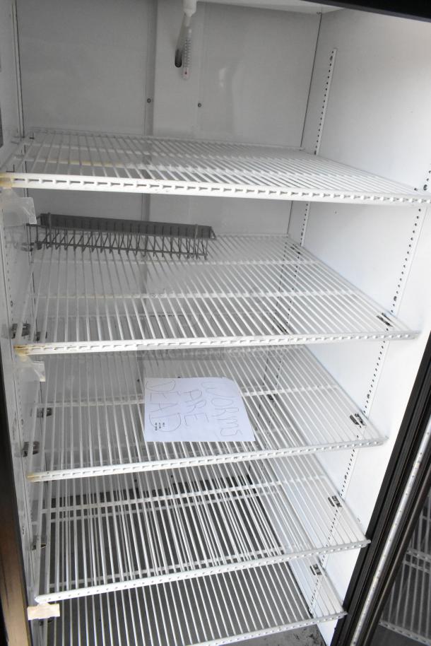 2023 True GDM-26-HC commercial cooler, single glass door, poly-coated racks, 115 volts, excellent condition.