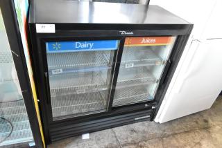 2018 True GDM-41SL-48-HC-LD cooler, 2 glass doors, poly-coated racks, "Dairy" and "Juices" signage, commercial use.