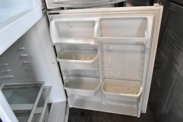 Maytag M1TXEGMYW01 metal cooler with freezer, interior view. Features adjustable shelves and door bins. Slight wear visible.
