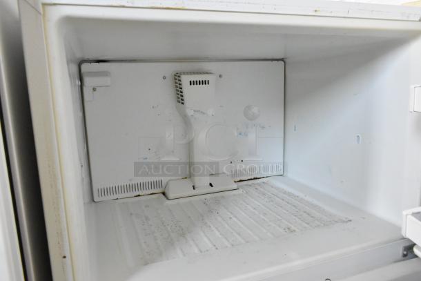Whirlpool W1TXNMFWQ00 metal cooler with freezer interior, showing shelves and ventilation. Signs of wear visible. 115 volts, 1 phase.