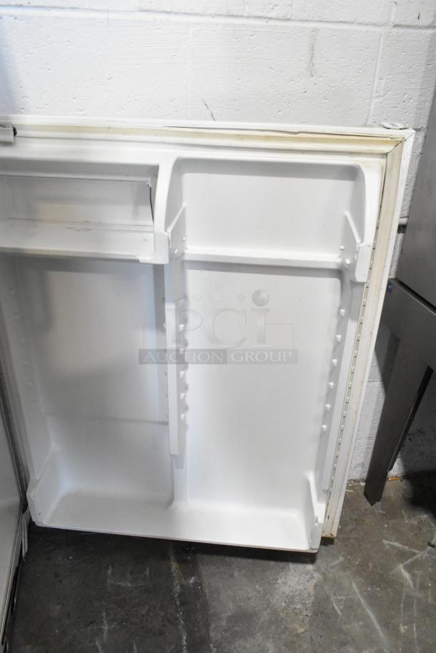 Whirlpool W1TXNMFWQ00 metal cooler door interior. Visible compartments; 115 volts, 1 phase. Good condition.